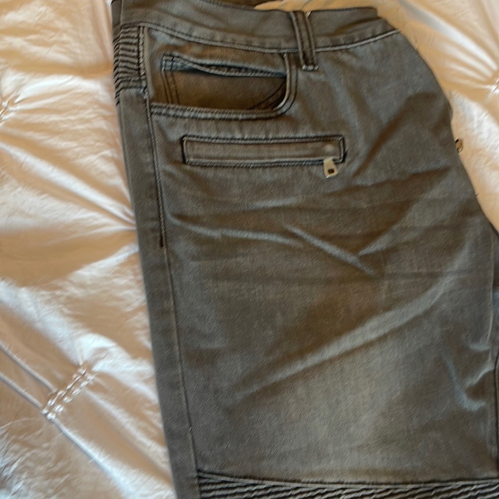 Washed grey denim jeans pockets front and back.